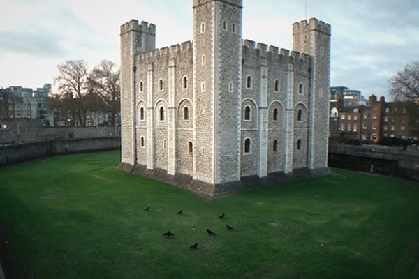 Historic stone fortress by the river with crenellated walls and towers