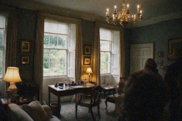 Grand gallery interior with classical paintings hung in rows under a glass ceiling