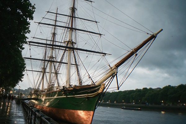 Cutty Sark sailing ship in its dry dock at Greenwich with masts against the sky